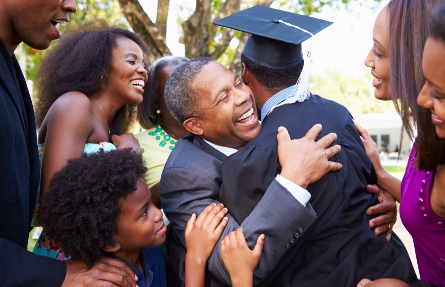 Family photo hugging graduate